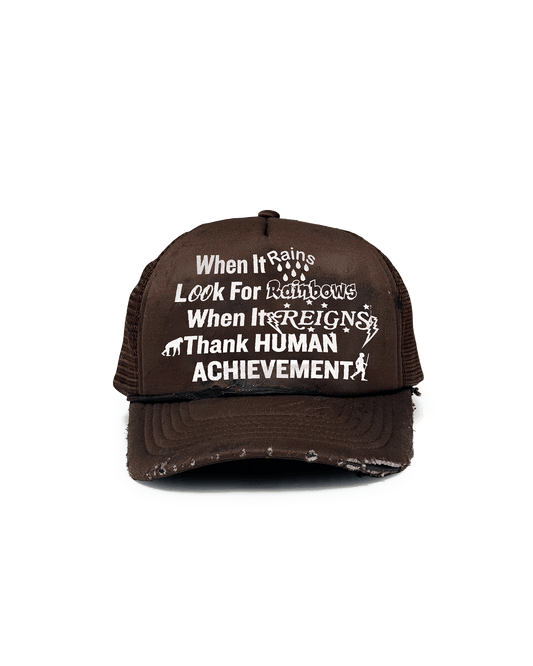 A brown Sunshine Reigns trucker hat with a vinyl print on the front